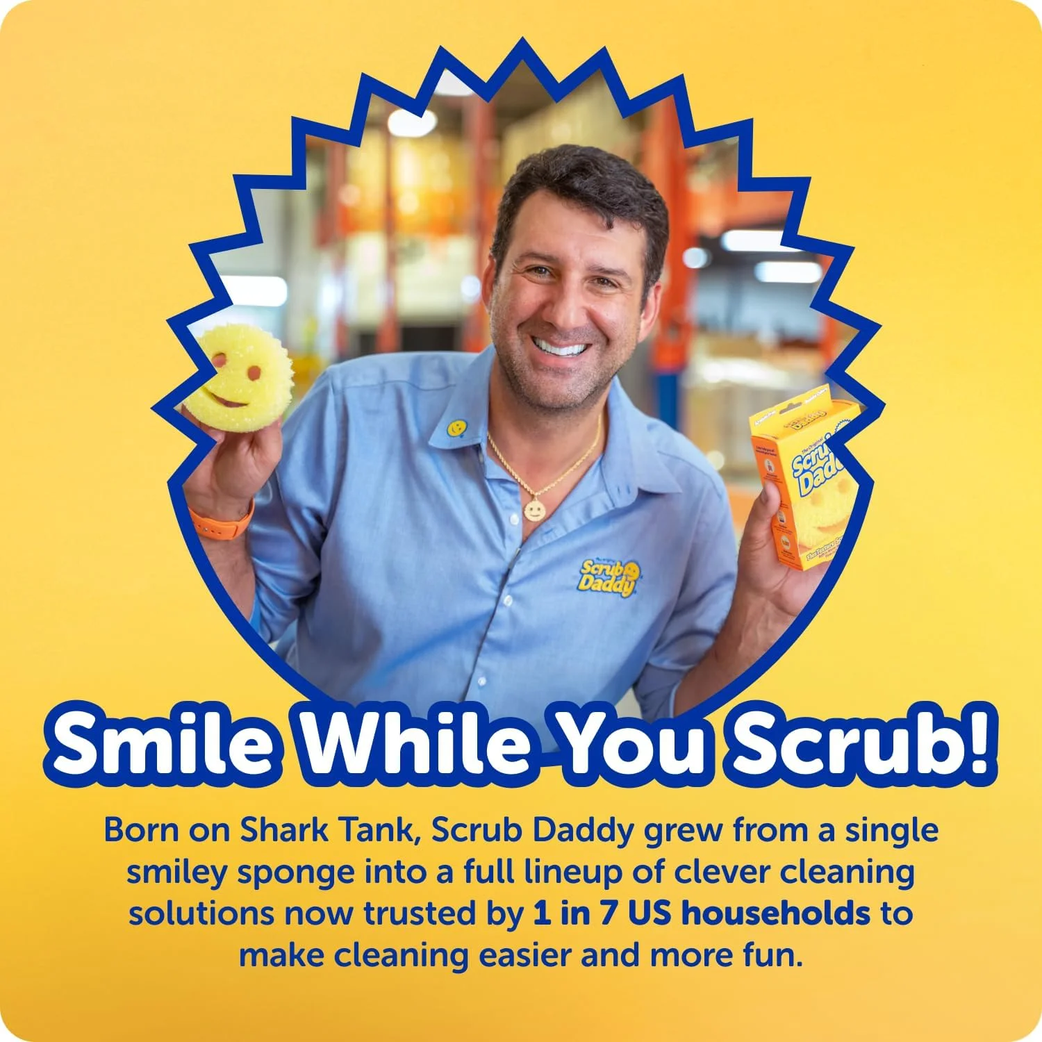 A smiling man holding a yellow smiley face sponge and a product box in a warehouse setting.